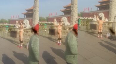 这么冷的天，天安门广场女主脱光衣服举起双手成投降状，前身写着似乎是广州黑暗，不知道要干嘛！